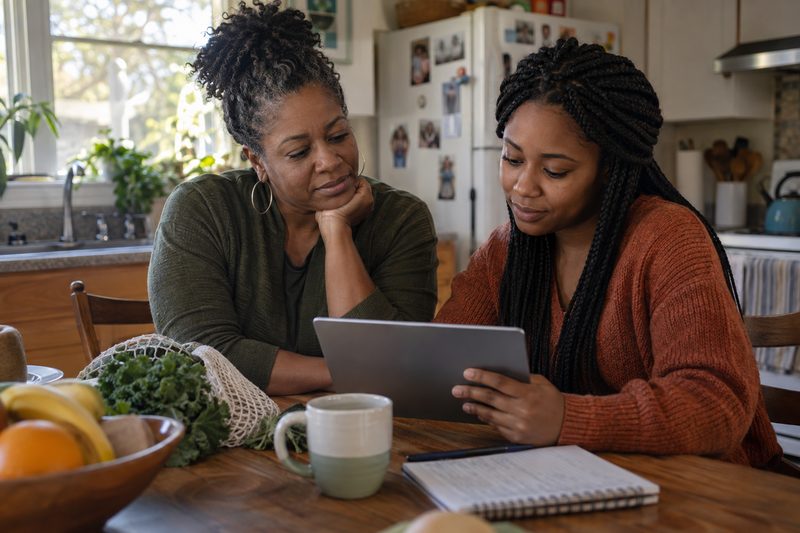 A person reviewing wellness articles and resources on a tablet at home.