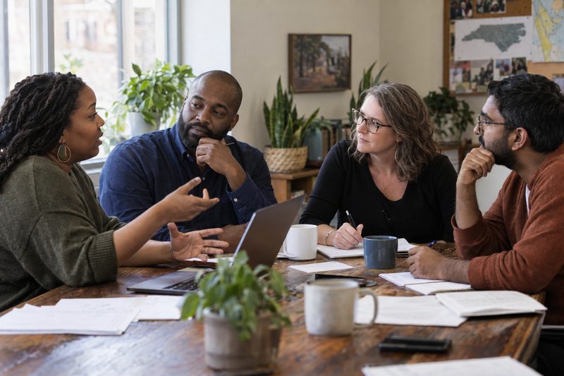 A group of professionals in a collaborative planning meeting.